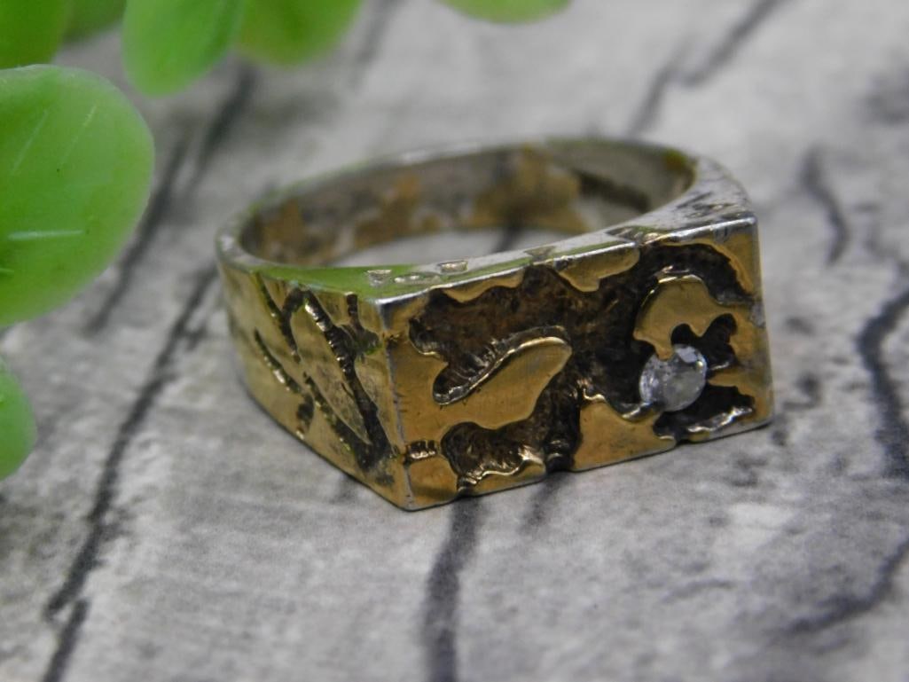 Gold Tone Ring with Clear Stone, Size 10: Gold tone ring featuring a textured design with a clear stone accent. Marked as size 10. Shown next to a quarter for scale comparison. The item is labeled for a 2024 antique auction at Lot 295 as indi