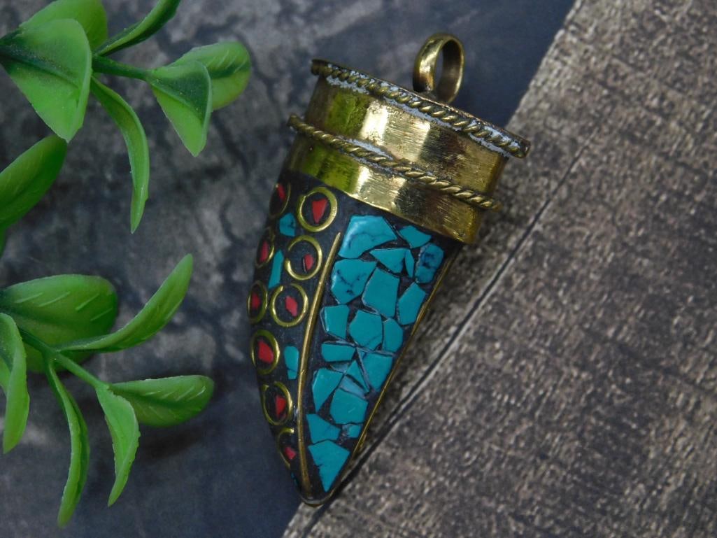 Turquoise and Red Coral Pendant with Mosaic Detail: A unique pendant featuring a cone-shaped design incorporating turquoise mosaic patterns and vibrant stone detailing. The pendant has a brass casing with decorative accents and is designed with a loop