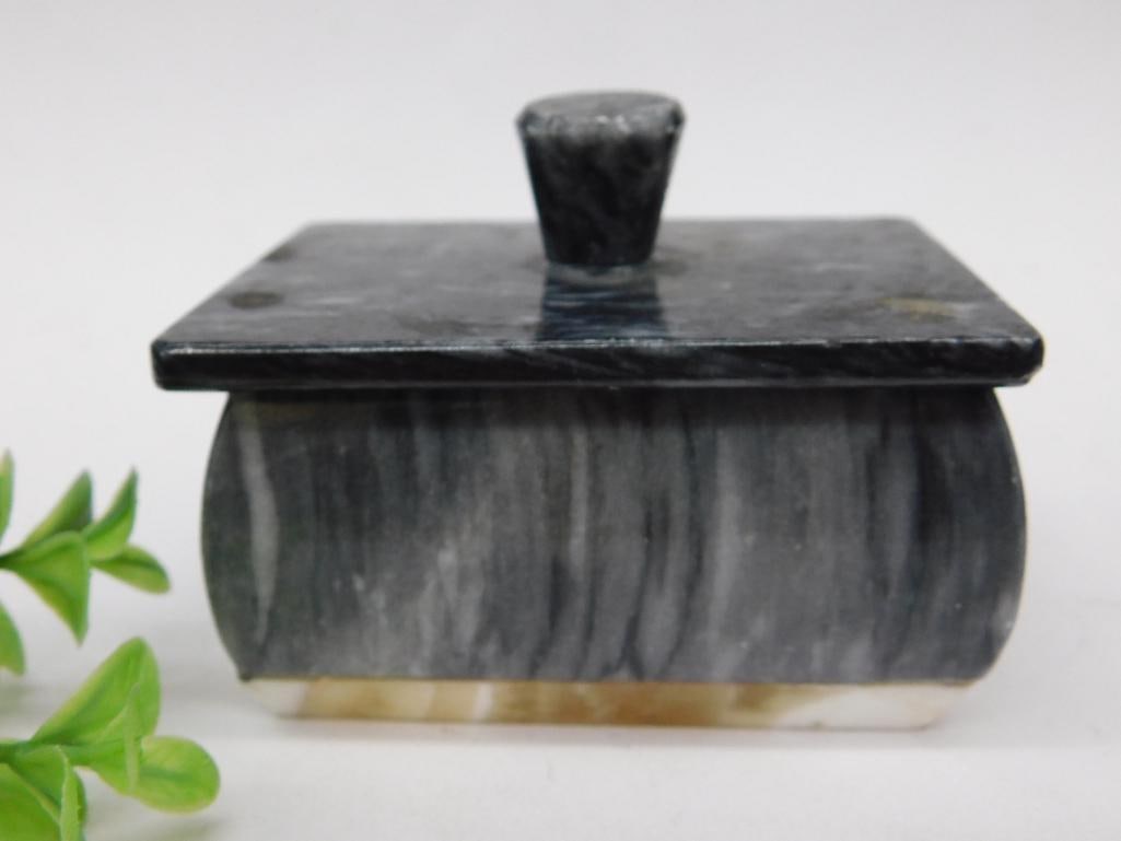 Marble Lidded Box With Unique Grain Pattern: This small lidded box is made from polished marble and features a distinctive grain pattern. The rectangular box comes with a fitted lid that includes a matching marble handle. Ideal for small storage