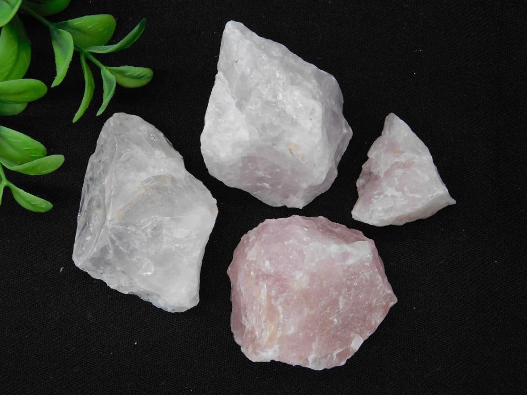 Four Raw Rose Quartz Crystal Specimens Rock Stone Lapidary Specimen: A lot of four raw rose quartz crystal specimens with beautiful natural textures. The total weight of the lot is approximately 166 grams. These crystals are shown alongside a quarter for size compariso