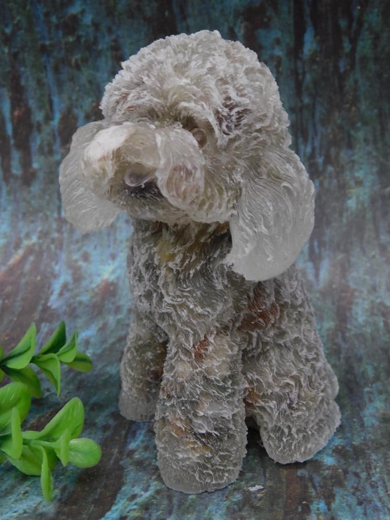 Stone Dog Figurine with Curled Features ROCK STONE LAPIDARY SPECIMEN: This is a textured glass figurine depicting a small curled dog. The figure has intricate detailing throughout to replicate the texture of fur. Its translucent nature enhances the dimensional quality o
