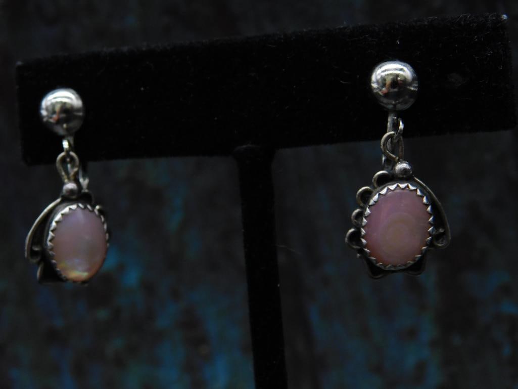 Signed Paul Stewart Screw-Back Earrings with Pink Stones: A pair of screw-back earrings signed by Paul Stewart featuring oval pink stones set in a decorative silver-tone setting. The earrings include a secure screw-back fastening mechanism, making them suita