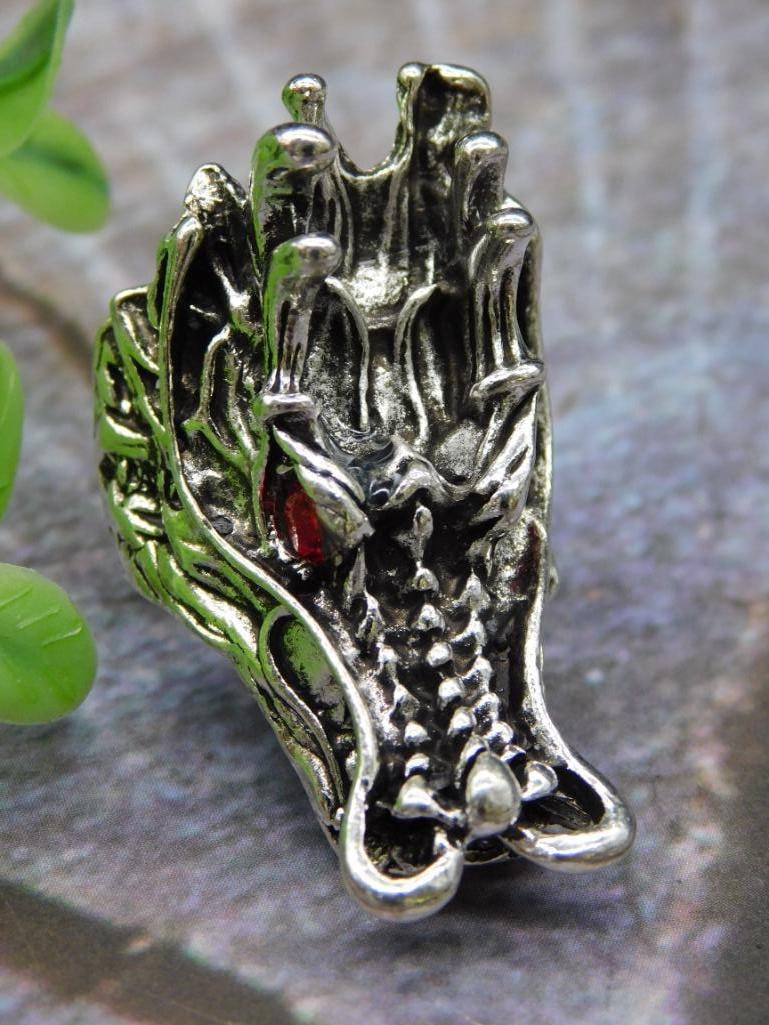 Silver-tone Dragon Claw Ring, Size 7: Silver dragon claw ring featuring intricate, detailed design work. Size 7 noted on the listing card. The back of the ring curves to stabilize its fit. Accompanied by a scale reference with a U.S. quar