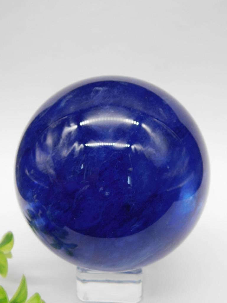 Deep Blue Sphere Weighs 1lb 4oz Rock Stone Lapidary Specimen: This listing features a deep blue spherical object with a smooth finish, displayed on a clear stand. It weighs 1 pound and 4 ounces and measures approximately 2 to 3 inches in diameter. Ideal for coll