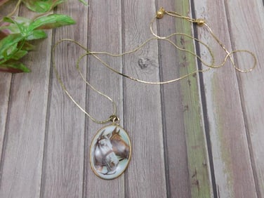Oval horse pendant necklace on gold-tone chain