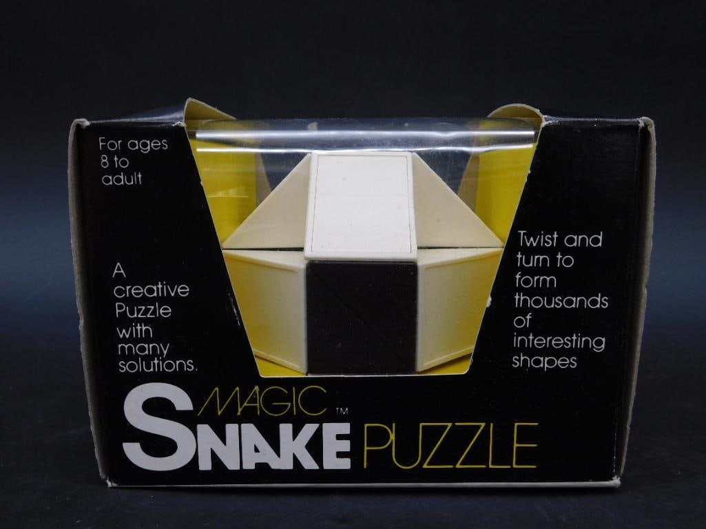 1982 Magic Snake Puzzle by HIRSHCO, Inc.: Magic Snake Puzzle in original box, dated 1982. This puzzle features over 23 trillion combinations to form thousands of interesting shapes. Suitable for ages 8 to adult. Includes an instruction and sh