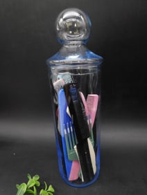 Glass Jar With Lid Containing Assorted Combs