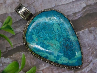 Turquoise Teardrop Pendant With Ornate Silver Tone Backing