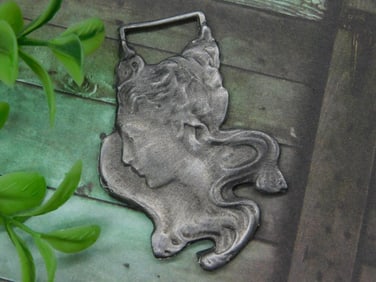 Silver-Toned Decorative Metal Watch Fob With Face Design