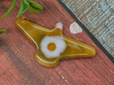 Yellow and White Stone Shaped as Flying Bird