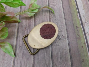 Oval brass belt buckle with wooden inlay