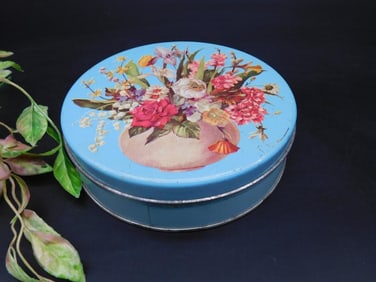 Round Blue Tin Container With Floral Design on Lid