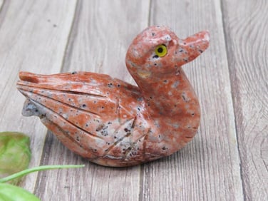 Carved Stone Duck Figurine with Red and Black Speckled Finish