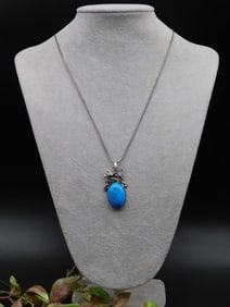 Pendant Necklace With Blue Stone and Ornate Metalwork