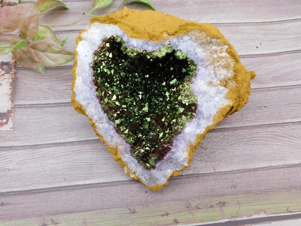 Heart-Shaped Druzy Crystal Geode: This heart-shaped geode features a glittering green druzy interior surrounded by white quartz and a contrasting yellowish-brown matrix. Ideal for display or collection purposes, it weighs approximatel