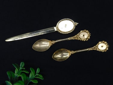 Gold-Colored Metal Letter Opener and Two Decorative Spoons