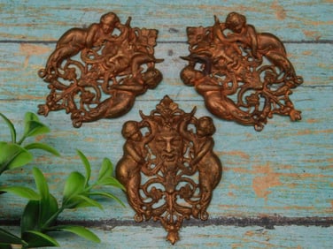 Set of Three Ornamental Metal Plaques with Cherub Design