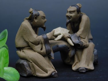 Detailed Figurine Depicting Two Seated Men in Conversation