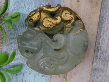 Carved Jade Pendant with Gold-Tone Accents Featuring Mythical Creatures