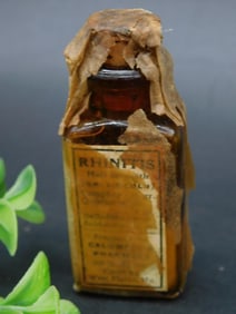 Brown Bottle with Partial Label and Paper Wrap