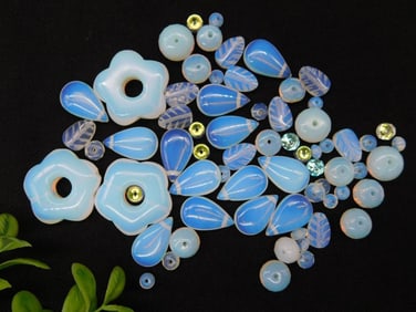 Assorted Blue and White Glass Beads Featuring Floral and Leaf Shapes