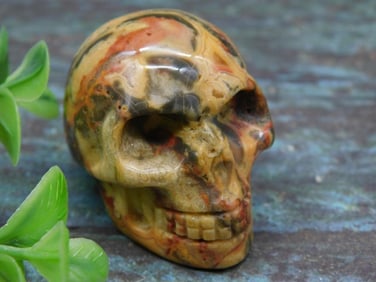Polished Multicolored Stone Skull Figurine