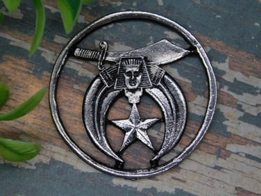 Metal Emblem with Crescent and Sword Design