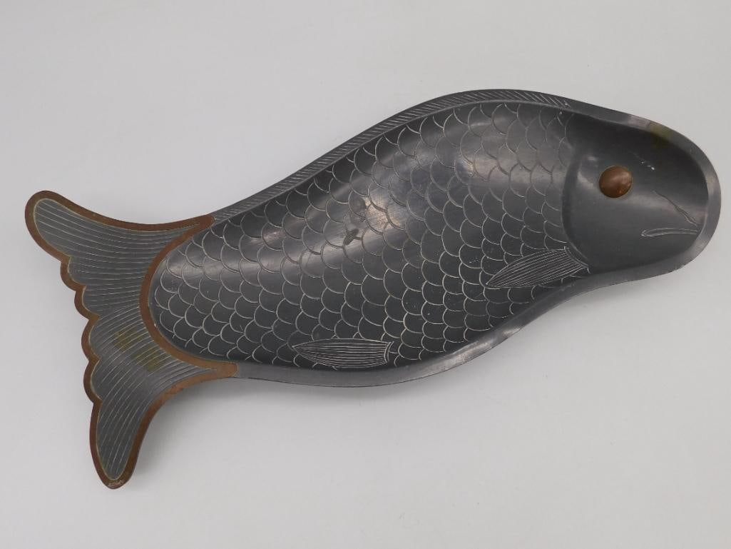 Handmade Fish-Shaped Decorative Tray From Hong Kong: This decorative tray is shaped like a fish and features detailed scale patterns. The item is handmade, as marked, with 'Hand Made in Hong Kong' inscribed on the surface. Its underside is equip