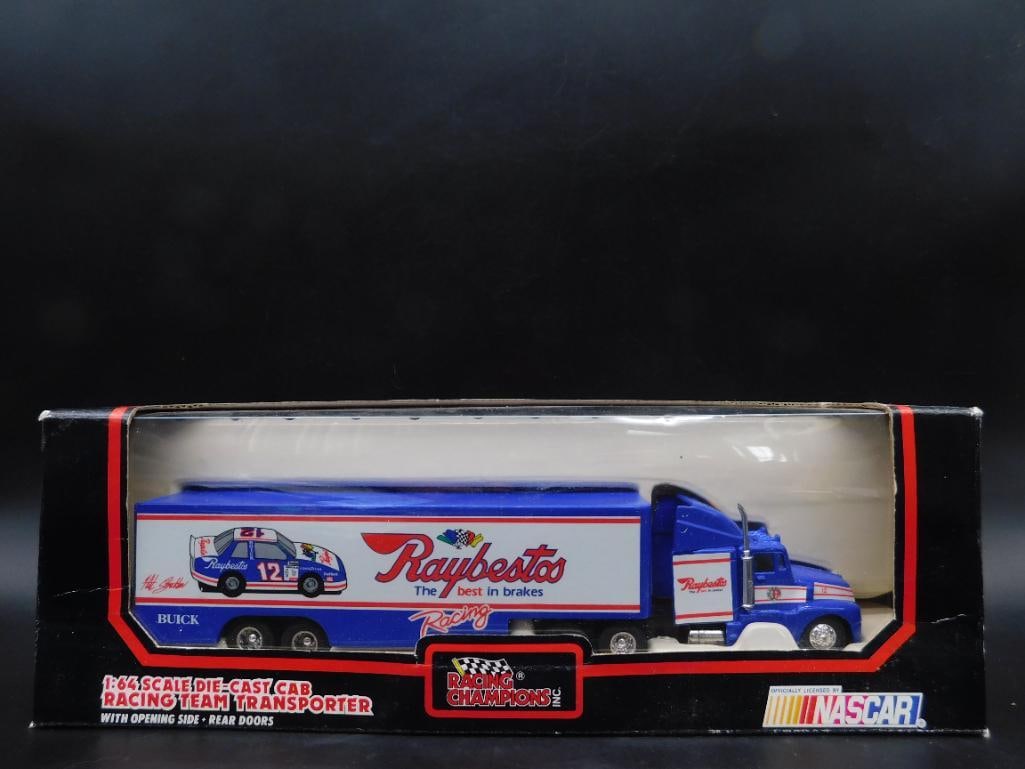 1:64 Scale NASCAR Racing Team Transporter NIB: This is a 1:64 scale die-cast NASCAR Racing Team Transporter. The set features a Raybestos No. 12 vehicle design on the truck and trailer. It includes functional opening side and rear doors. The item 