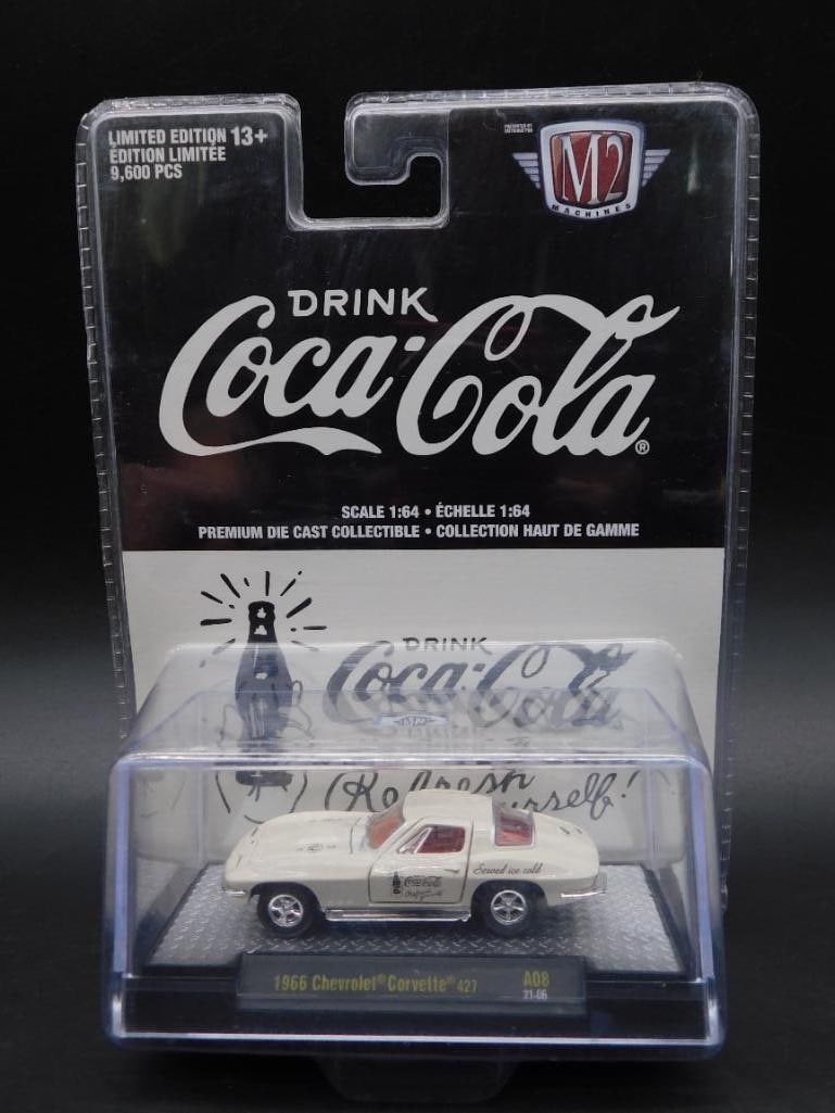M2 Machines Coca-Cola 1966 Dodge Charger Die-Cast Model: Limited edition 1966 Dodge Charger die-cast model by M2 Machines in Coca-Cola branding. Factory-sealed in original packaging, featuring the 'Drink Coca-Cola' slogan and details. Includes collector-fri