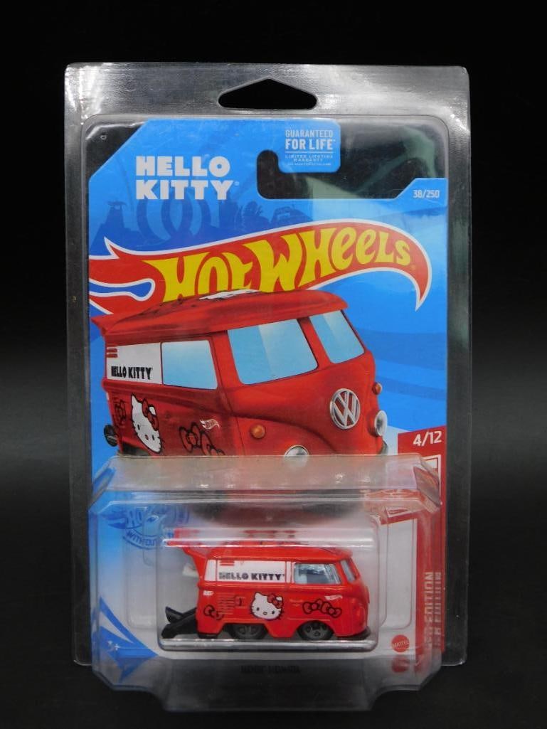 Hot Wheels Hello Kitty Kool Kombi Die-Cast Vehicle: Hot Wheels Hello Kitty-themed Kool Kombi die-cast vehicle in red. Packaged in its original unopened blister pack. Features Hello Kitty graphics on the vehicle. Manufactured in 2021 as part of the Prem