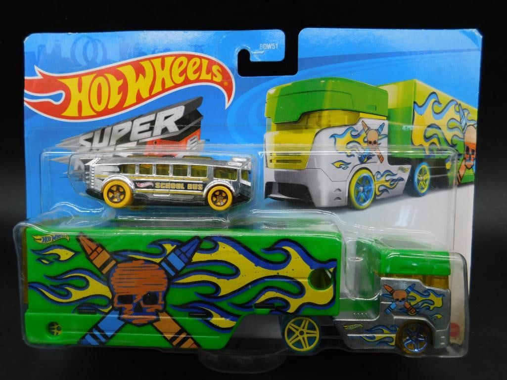 Hot Wheels Super Rigs Pencil Pusher Set: Hot Wheels Super Rigs Pencil Pusher set featuring a colorful truck and matching vehicle. Includes Skull and crossbones design on the truck and trailer. Original packaging is sealed. Back of the packag
