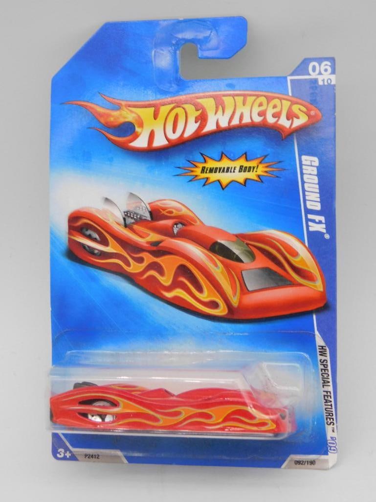 Hot Wheels Ground FX in Original Packaging: This Hot Wheels model, Ground FX, is part of the HW Special Features series. Manufactured in 2007 and made in Malaysia, it features a distinctive red body with flame graphics. The car remains in its o