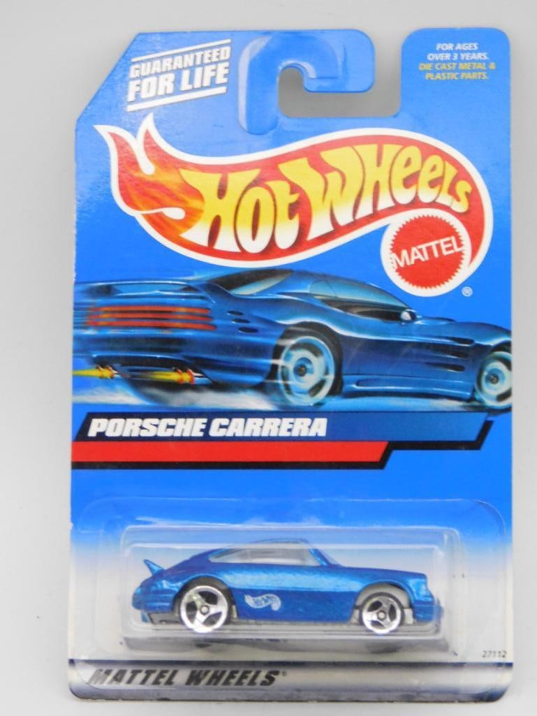 Hot Wheels Porsche Carrera 2000 Blue in Original Packaging: This listing features a Hot Wheels Porsche Carrera die-cast car in blue, produced by Mattel. It is in its original 2000 packaging, unopened. The card has some visible wear but remains intact. The pack