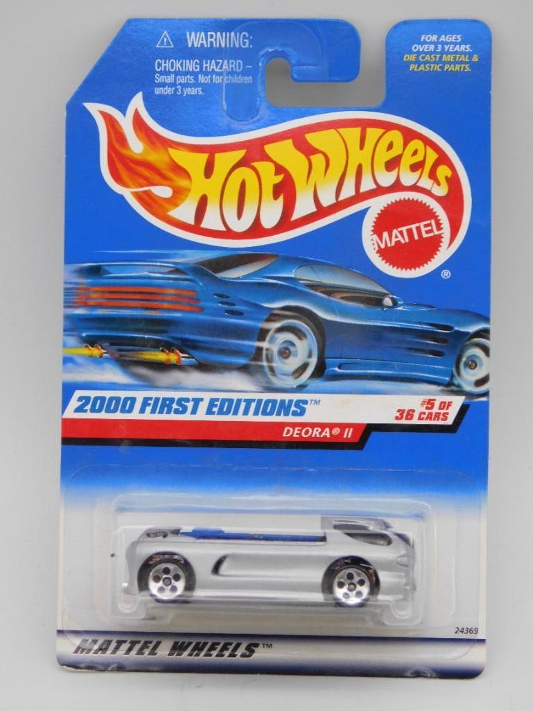 Hot Wheels 2000 First Editions Deora II, Sealed: Hot Wheels 2000 First Editions Deora II die-cast car, #5 out of 36 cars in the series. The packaging is intact and sealed. Features detailed graphics on the car and card. Backside includes product and