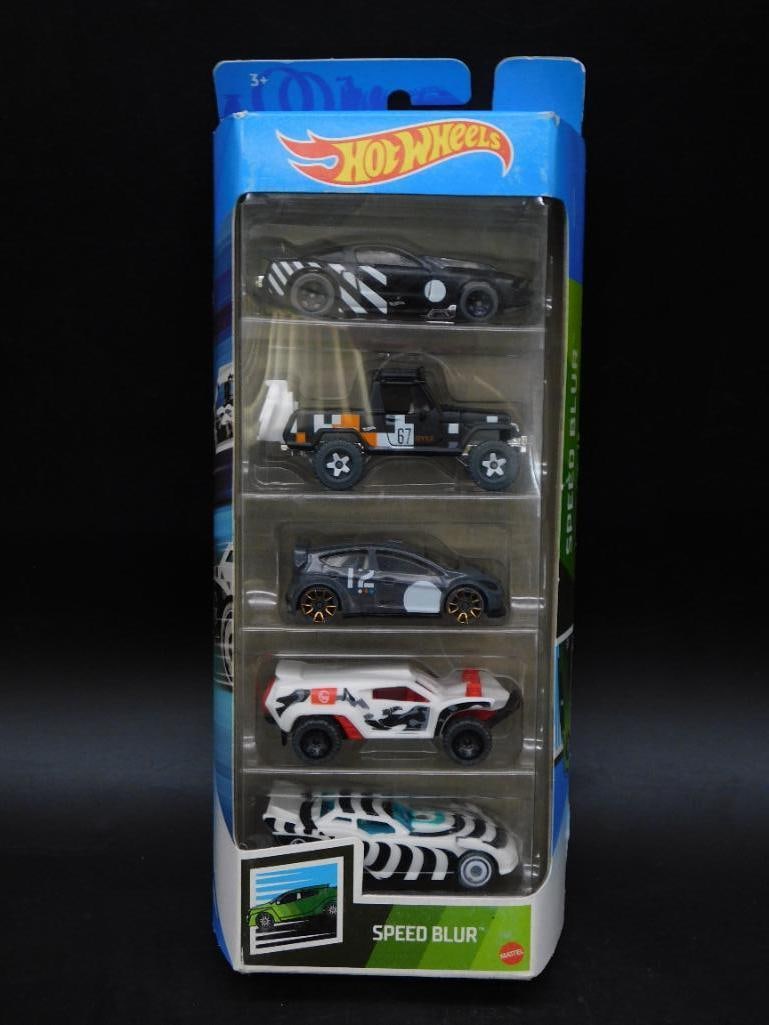 Hot Wheels Speed Blur 5-Car Gift Pack: Hot Wheels Speed Blur 5-Car Gift Pack includes 5 unique vehicles featuring bold designs and speedy styling. The package remains unopened, showcasing all cars securely encased in their original packagi