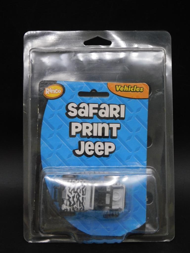 Safari Print Jeep Toy in Original Packaging: This item is a die-cast Safari Print Jeep toy, sealed in its original plastic packaging. The vehicle features a zebra-stripe pattern with black detailing and off-road tires. The package includes origi