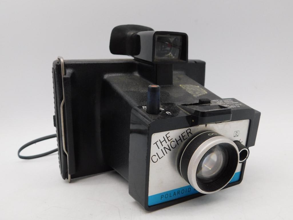 Polaroid The Clincher Model Instant Camera: Polaroid The Clincher camera featuring a manual focus system, designed for instant photography. Includes integral viewfinder and cold-clip for film processing. Comes with an easy-to-follow instruction