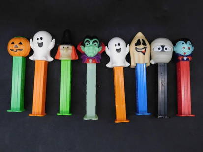 Set of 8 Halloween-Themed PEZ Dispensers: Lot includes 8 Halloween-themed PEZ candy dispensers featuring festive characters such as a pumpkin, ghosts, a witch, Dracula, a mummy, and a skull. Manufactured in Hungary with US patent 4,966,305 st