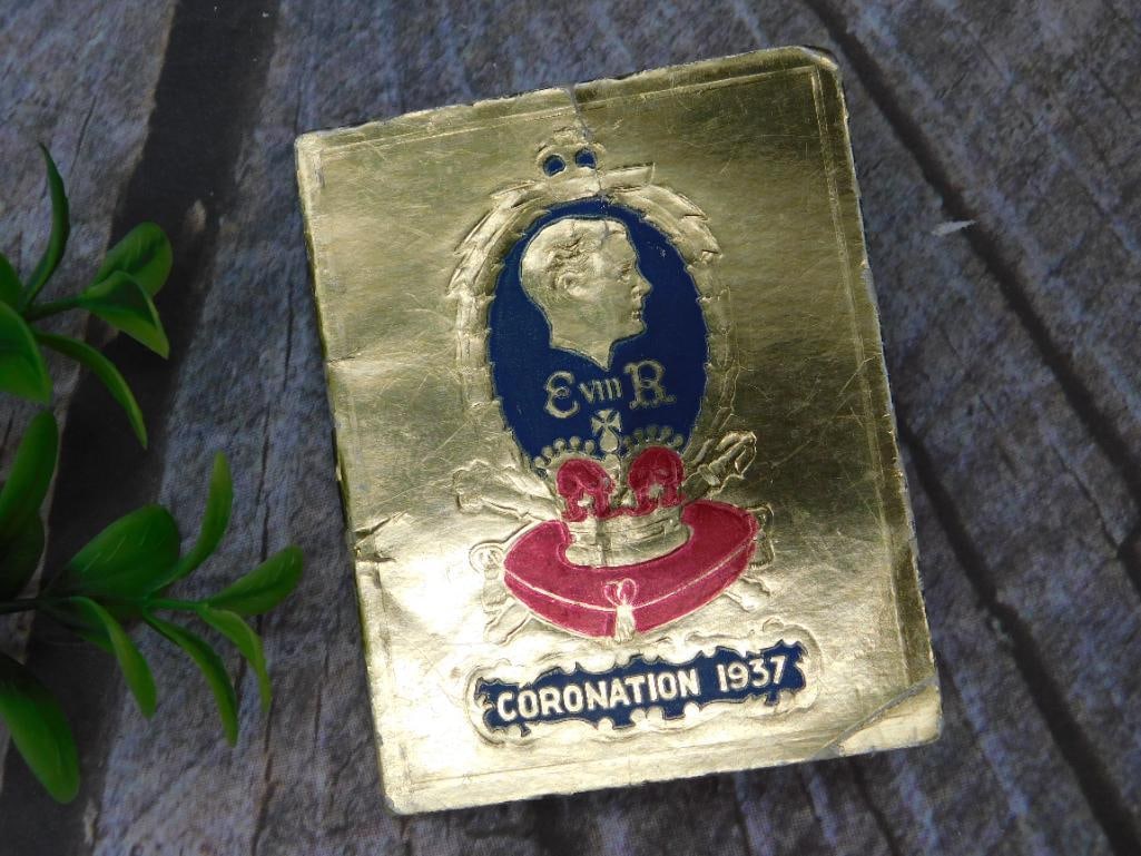 1937 King Edward VIII Coronation Calendar Booklet: This is a 1937 King Edward VIII Coronation calendar booklet featuring illustrations and a monthly calendar for the year 1937. The cover is gold-toned with embossed designs commemorating the coronation