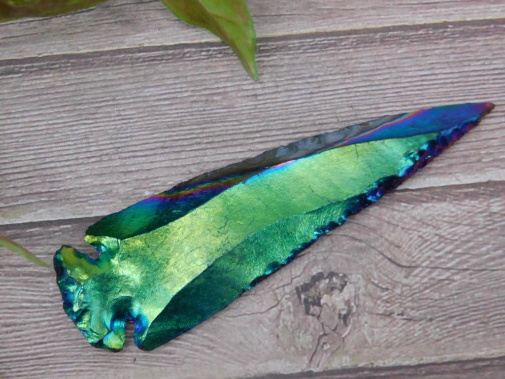 RAINBOW OBSIDIAN HAND KNAPPED ARTIFACT ROCK STONE LAPIDARY SPECIMEN: A vibrant iridescent obsidian arrowhead with a striking color-changing surface. The piece measures approximately 4 inches in length, as shown in the image with a ruler. It features a hand-knapped desi