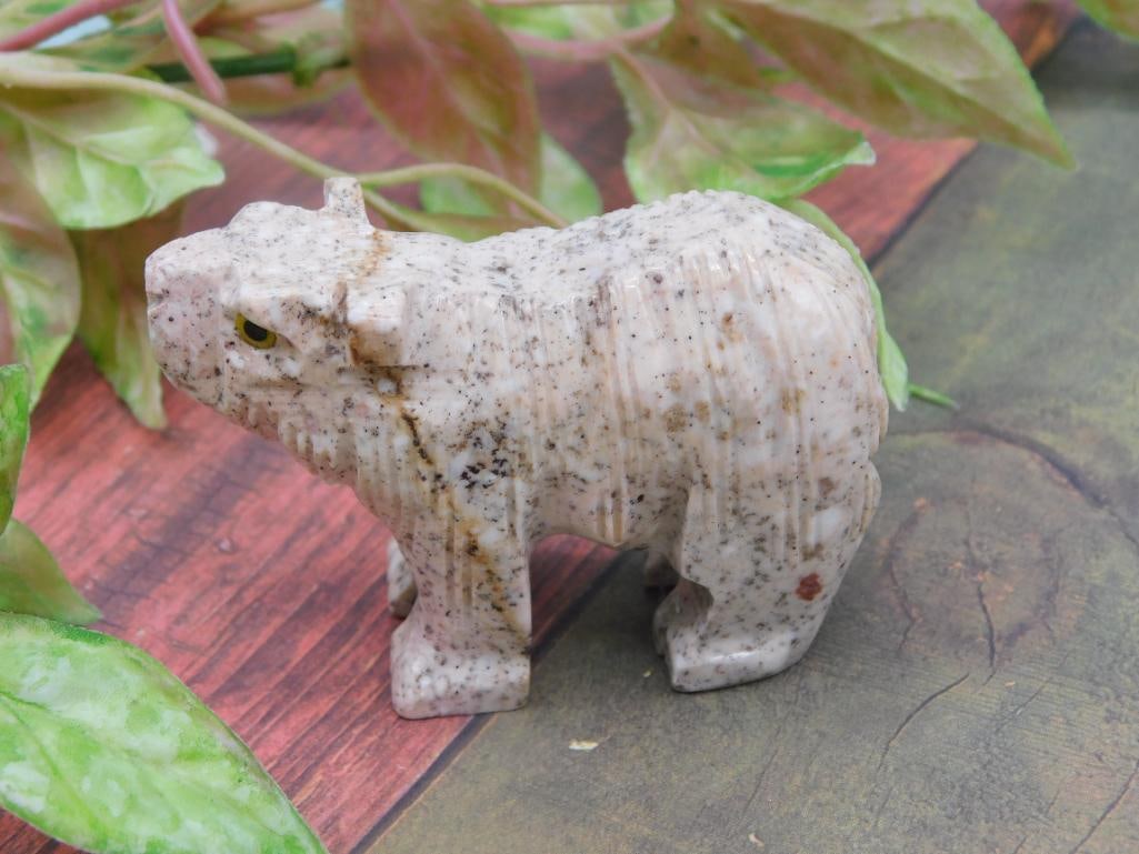 Carved Stone Animal Figurine With Yellow Eyes ROCK STONE LAPIDARY SPECIMEN: Carved stone animal figurine, possibly representing a big cat or similar creature. Features speckled stone material with detailed textures and carved yellow eyes for added realism. Dimensions not spec
