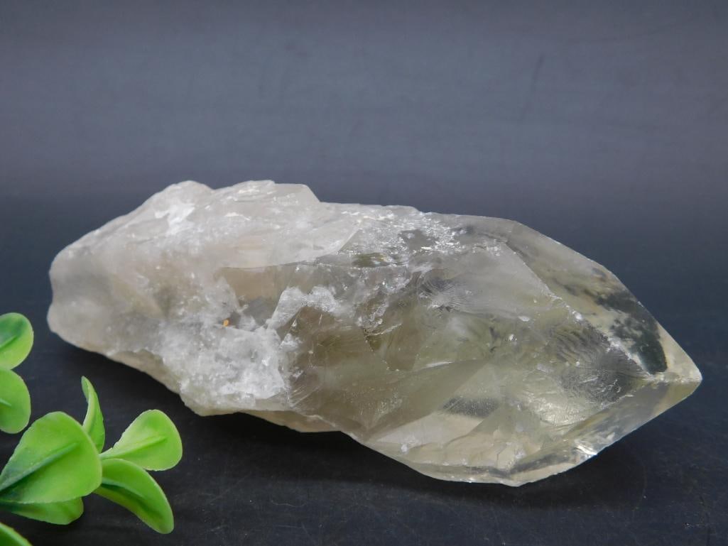 Natural Clear Quartz Crystal Point, 253g: - Natural clear quartz crystal specimen. | - Weighs approximately 253 grams. | - Measurement visible with the included ruler scale. | - Features a pointed end with raw and natural surfaces. | - Color