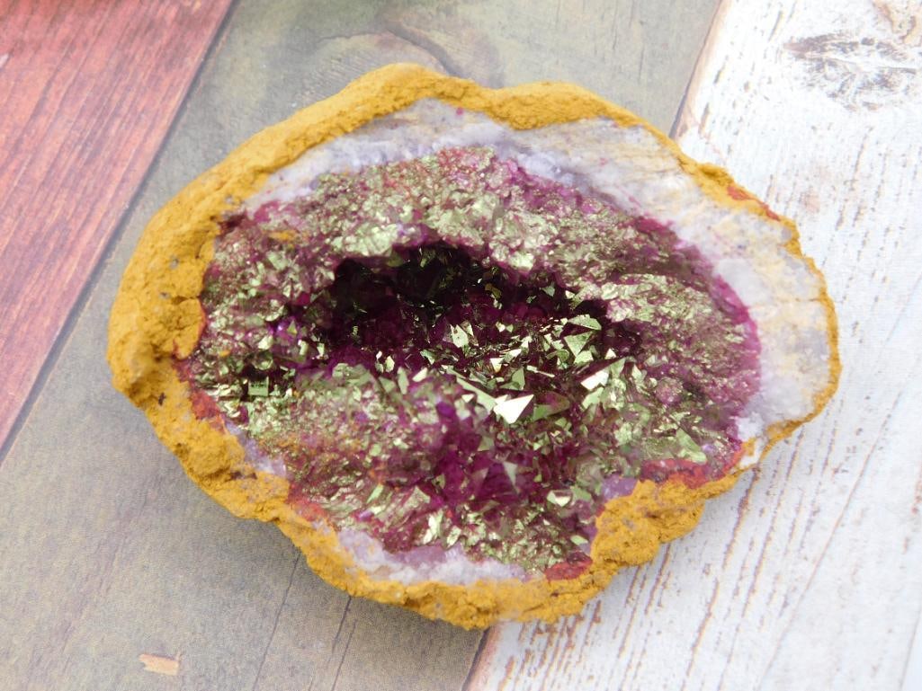 GEODE ROCK STONE LAPIDARY SPECIMEN: Natural geode featuring a gold and purple crystal interior. The exterior consists of a yellow-hued formation surrounding the crystal cavity. Weighs approximately 135 grams. Ideal for collectors or dis