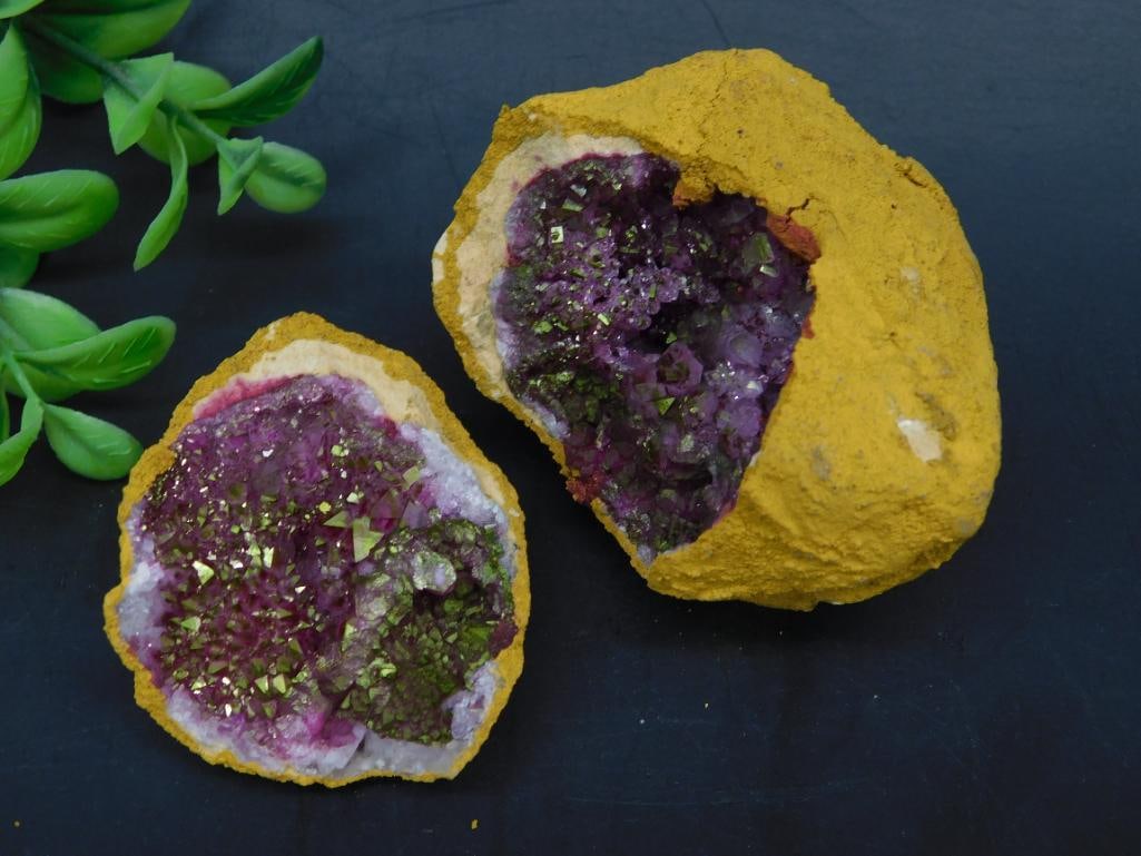 GEODE ROCK STONE LAPIDARY SPECIMEN: Purple amethyst geode featuring a vibrant display of crystals inside a rugged yellow-orange outer shell. Inner crystals are accented by natural metallic inclusions. The geode is split into two halves,
