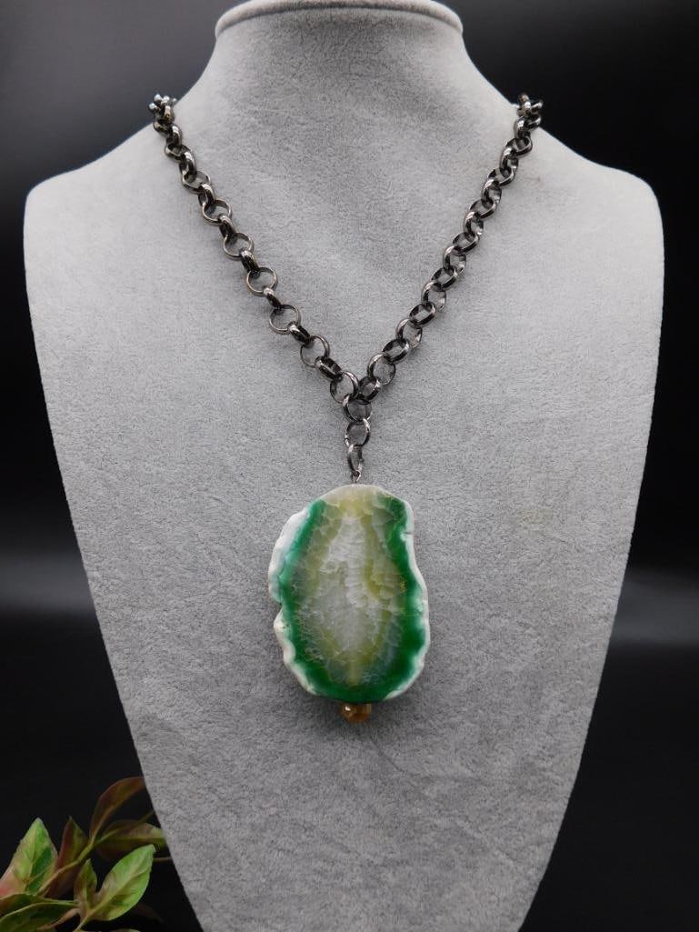 GUNMETAL NECKLACE WITH GREEN FIRE AGATE PENDANT ROCK STONE LAPIDARY SPECIMEN: This necklace features a green geode slice pendant with an organic shape, attached to a sturdy metal chain. The geode pendant showcases natural green and white tones. It is secured with a lobster clas