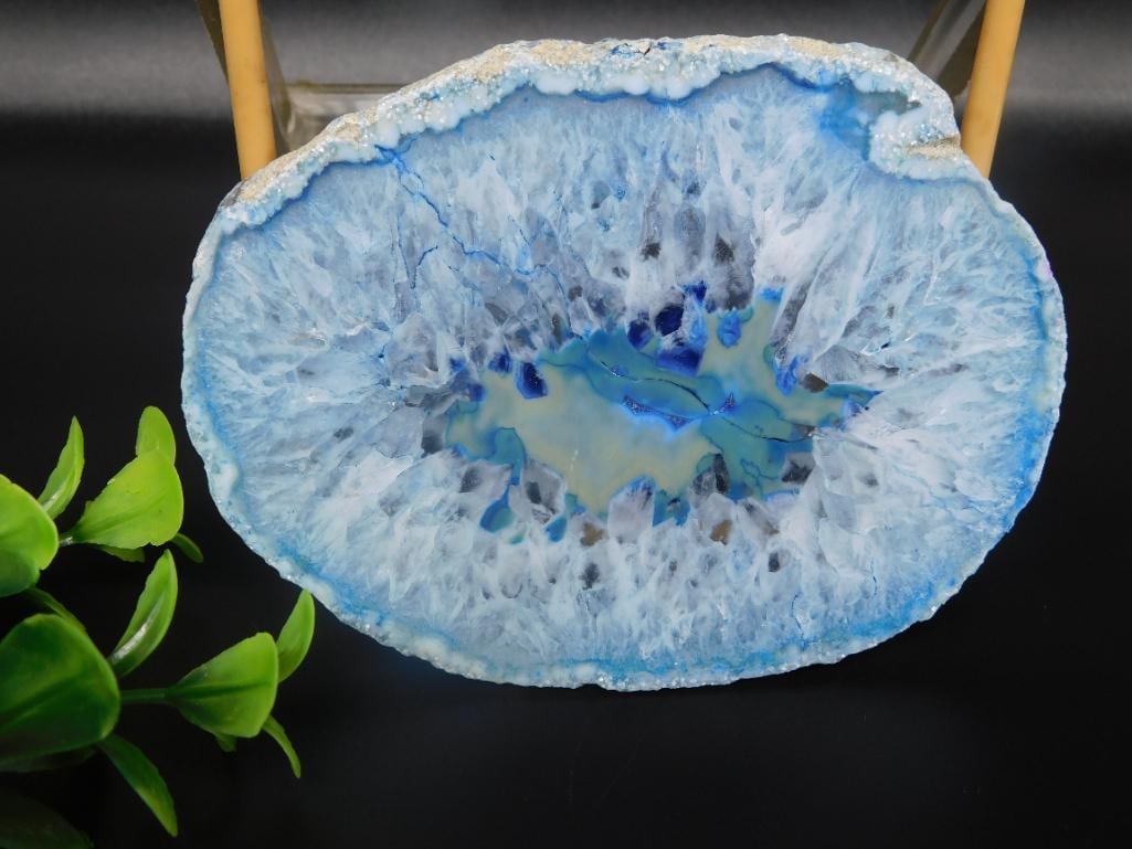 Blue Agate Slice Display Piece Rock Stone Lapidary Specimen: - A polished blue agate geode slice with a vibrant and natural pattern. | - Features rich blue and white hues with unique crystalline formations at the center. | - Measurements are provided in the ima