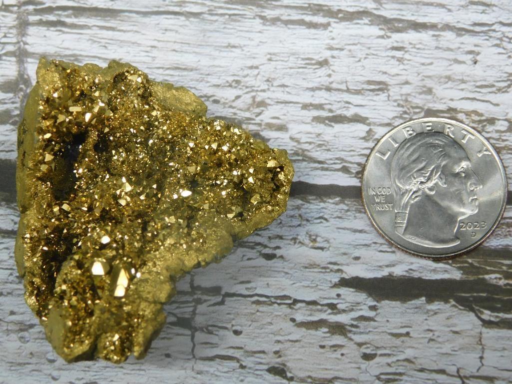 Alien Egg Geode Rock Stone Lapidary Specimen: - A gold-colored mineral specimen weighing 27 grams. | - Shown next to a standard U.S. dime for size comparison. | - Appears to have a shiny, textured surface with crystalline formations. | - Presente