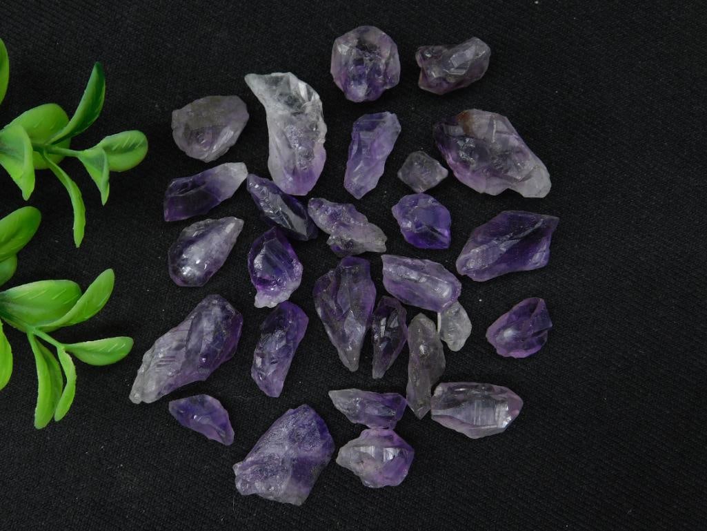 Collection of Amethyst Crystal Points: A lot of natural amethyst crystal points in varying sizes and shapes, as shown. Each piece exhibits vibrant purple hues typical of amethyst. The total weight is not specified, and a quarter is include