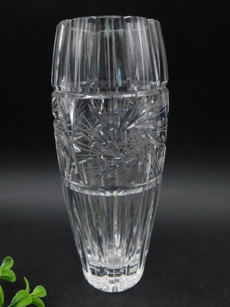 CUT CRYSTAL BUD VASE: Crystal clear bud vase with cut patterns along the body and bottom. The design includes vertical faceted stripes and intricate starburst motifs. Approximate length shown on image suggests compact dime